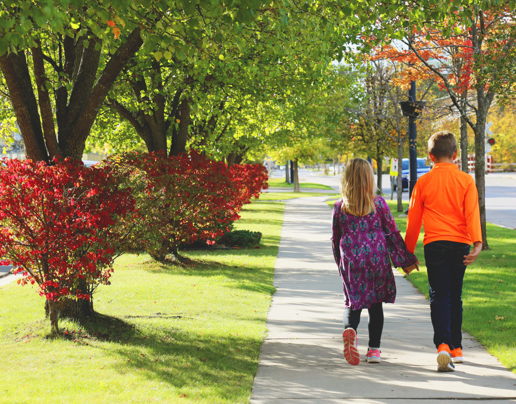 Fall in Downtown Mt. Pleasant Two children walk down Broadway Street in Downtown Mt. Pleasant, Michigan, enjoying the fall colors.
